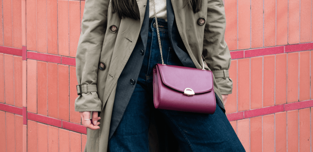 Sac vegan Mini Paname en cuir de pomme porté par une femme parisienne sur fond brique représentant la Maison Ashoka Paris